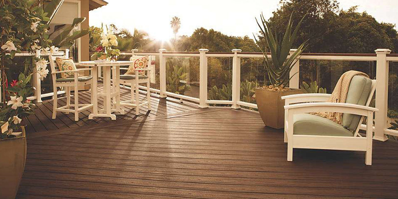 A bright glass railing with a built-in drink rail makes a deck look and function like it has more square footage than it does
