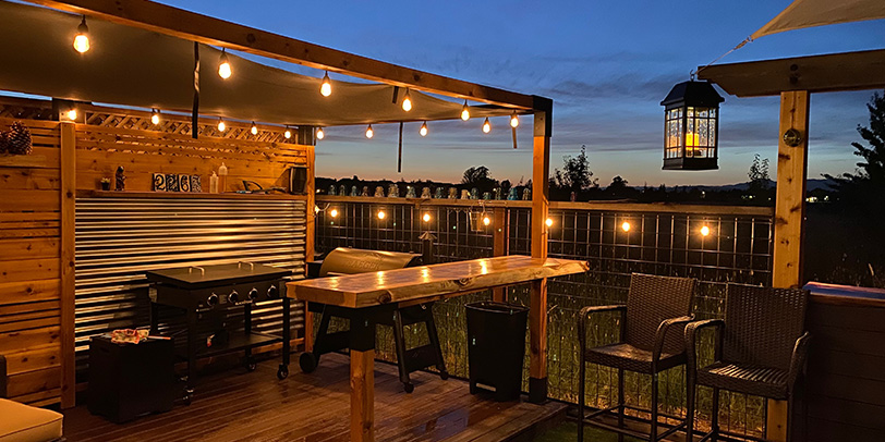 An example of a rustic pergola with gorgeous lighting at dusk