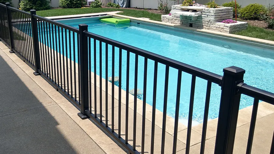 A stretch of Revival Rail deck railing by a luxurious pool