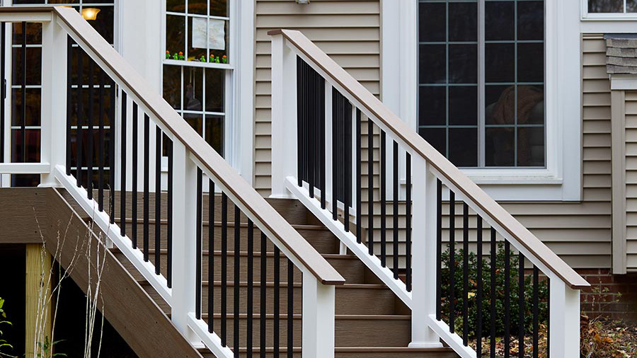 TimberTech Classic Composite Drink Rail extends down a section of stairs
