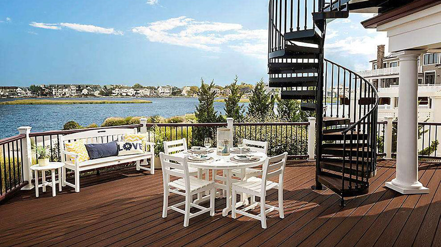 A luxurious deck with a large spiral staircase up to a second level